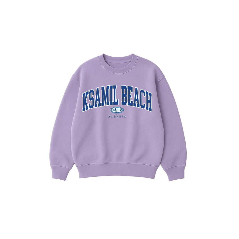 Purple sweatshirt with 'KSAMIL BEACH' text on a white background