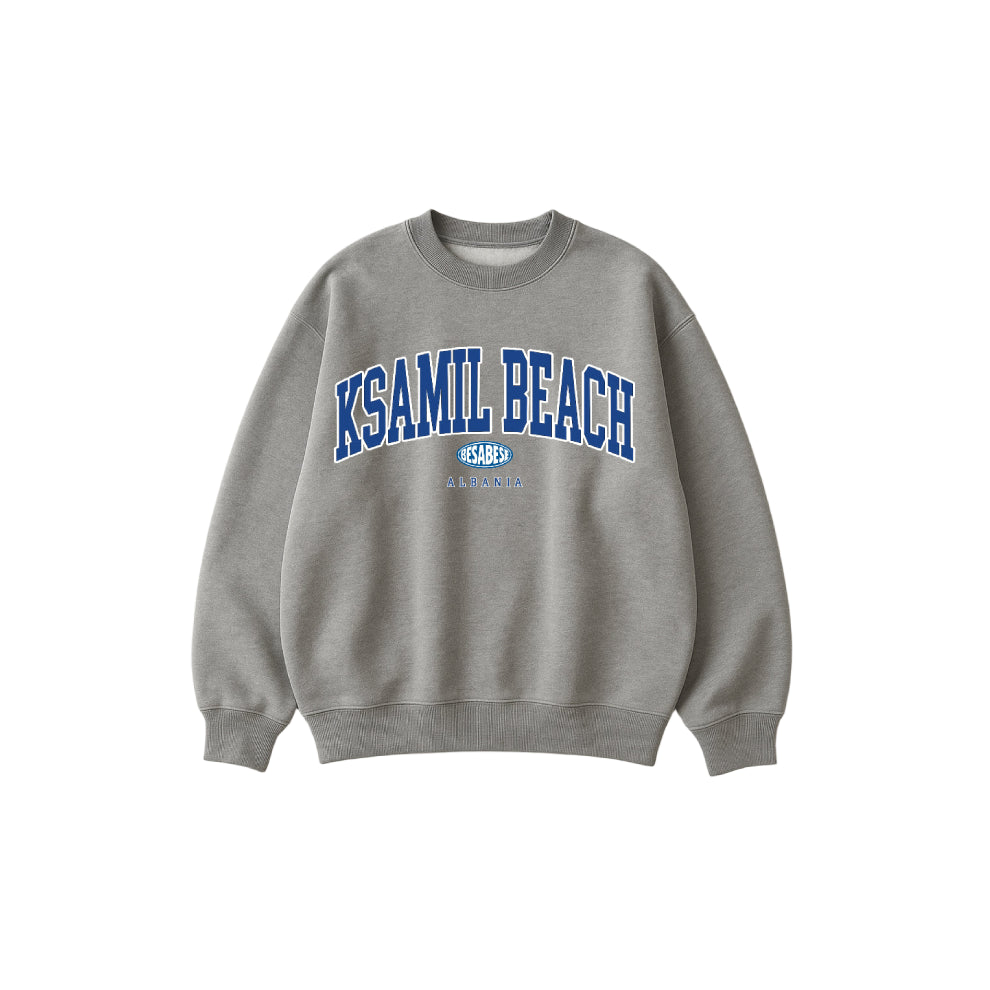 Gray sweatshirt with 'KSAMIL BEACH' text on a white background