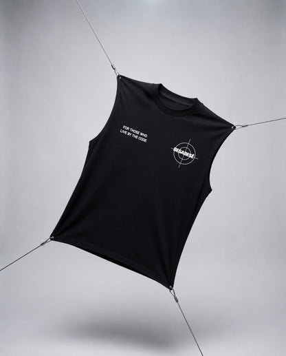 A black sleeveless crop top with white printed graphics, suspended by thin wires against a light gray studio background.