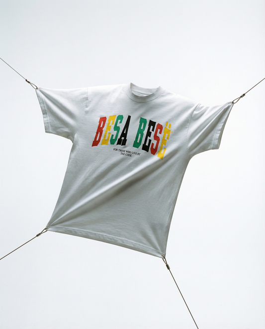 White t-shirt with colorful text 'BESA BESE' hanging on a line against a white background