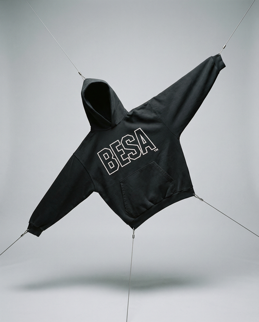 Black hoodie with 'BESA' branding on a light gray background