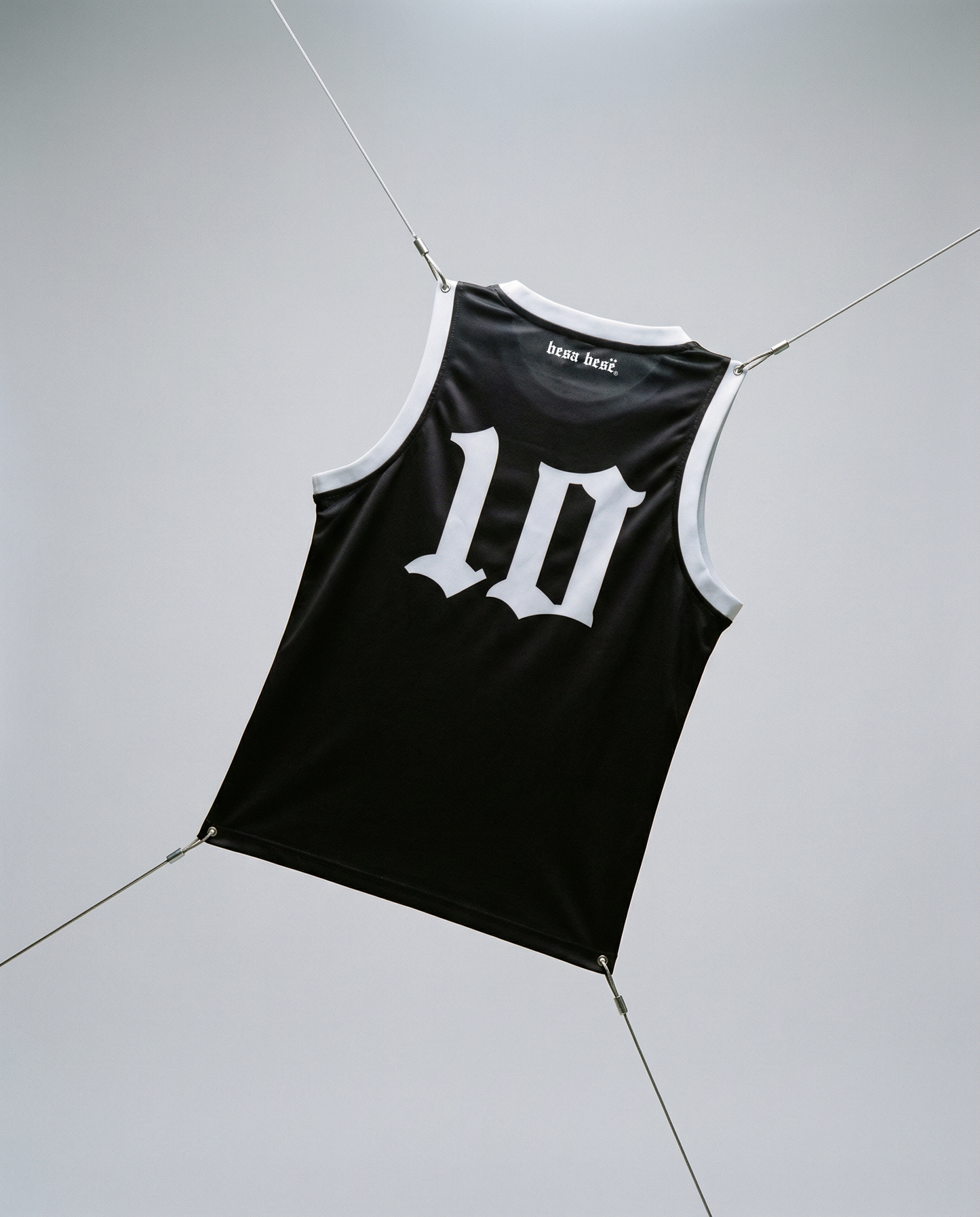 Black tank top with white number '10' on a light gray floor