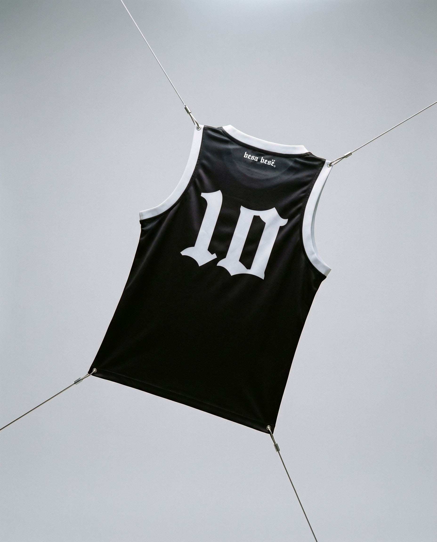 Black tank top with white number '10' on a light gray floor