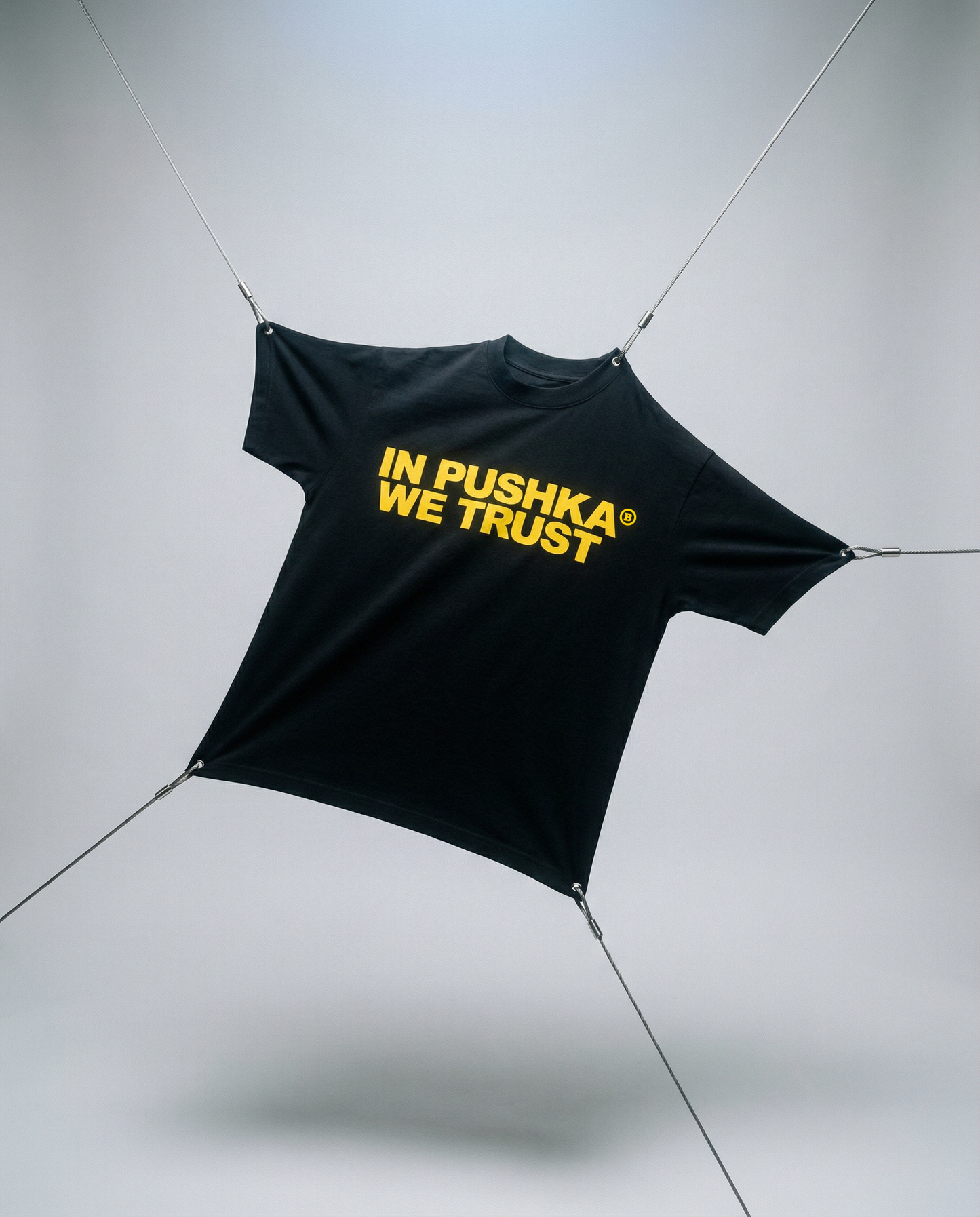 Black tarp with 'In Pushka We Trust' text on a gray background