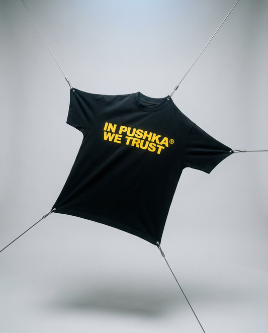 Black tarp with 'In Pushka We Trust' text on a gray background