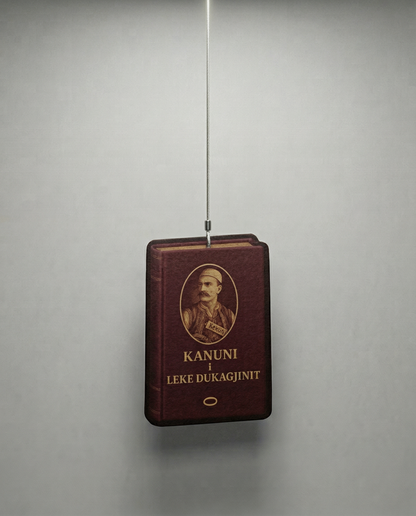 Vintage book with a portrait on the cover, hanging against a plain background