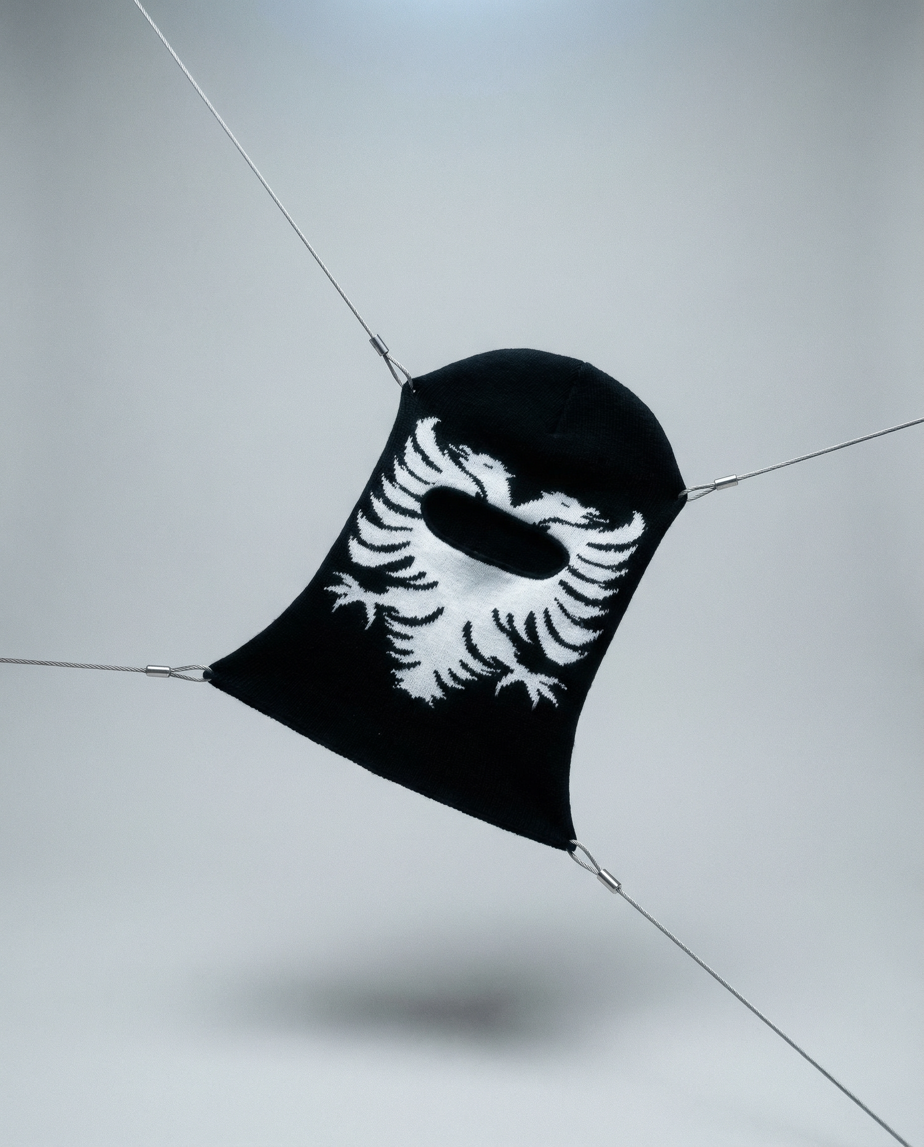 Black face mask with white design on a light gray background