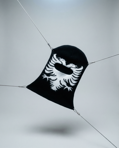 Black face mask with white design on a light gray background