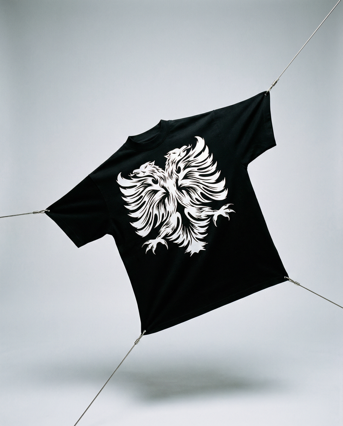 Black t-shirt with a white eagle design on a light gray background